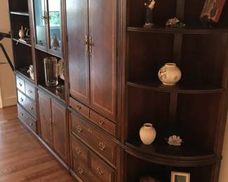 An incredible wall storage unit with multiple display areas, drawers and shelves.