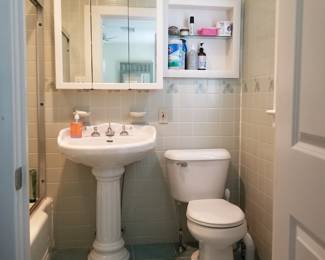 Pedestal sink; mirrored medicine cabinet; commode