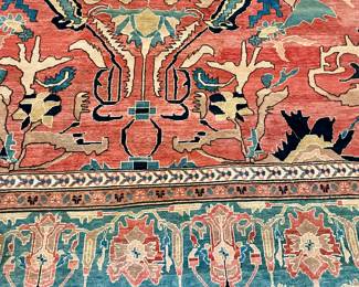 Pakistani Rug, 4th quarter 20th century. Wool on cotton. Sultanabad design.  The field is decorated with alrge floral and stylized leafy vines on a rosy red ground. The main border in medium blue, patterned with alternating palmettes, bracketed by leafy vines. Minor borders in ivory and camel.  Measurements: 18'6" L x 12'6" W. 