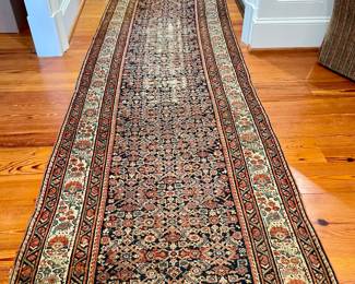 Malayer Persian, Central Iran early 20th century runner. Wool on cotton.  The field is decorated with an all over herati design on a deep navy ground. The main border in ivory, patterned with alternating stylized floral motifs.  Minor borders in navy.  Measurements: 15'10" L x 3'6" W