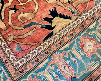 Pakistani Rug, 4th quarter 20th century. Wool on cotton. Sultanabad design.  The field is decorated with alrge floral and stylized leafy vines on a rosy red ground. The main border in medium blue, patterned with alternating palmettes, bracketed by leafy vines. Minor borders in ivory and camel.  Measurements: 18'6" L x 12'6" W. 