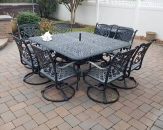 Cast aluminum outdoor dining set seats 8; includes cushions, pillows & umbrella