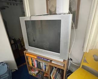 TV and shelf with books,