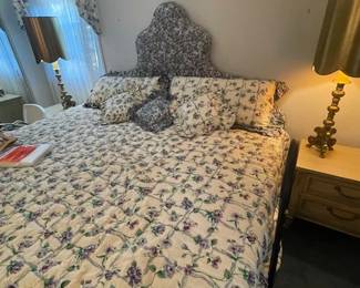 Queen size bed with upholstered headboard.