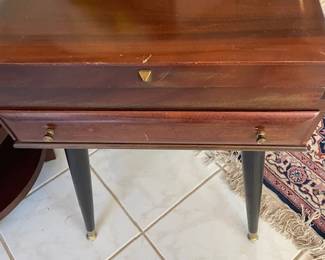 Flatware storage cabinet on legs.