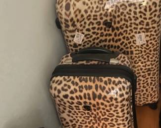 Brown leopard hardside luggage.