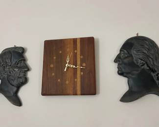 Lincoln and Washington cast iron wall plaques and MCM mixed wood wall clock.