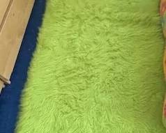 Three olive green throw rugs.