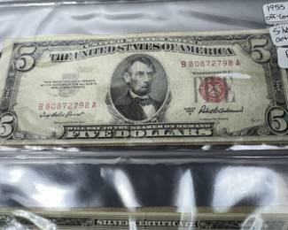 five dollar red seal silver certificate and blue seal five dollar silver certificate one dollar blue silver certificate. all with margin errors ultra rare