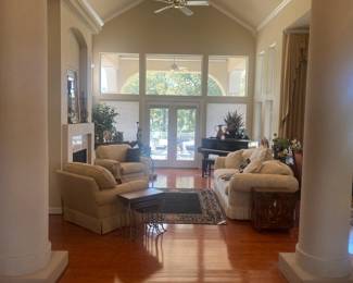 Light colored sofa and club chairs