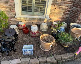 Lots of ceramic pots with stands with many more