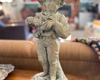 Beautiful vintage concrete boy holding apple 