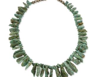 337
A large Southwest Pueblo turquoise tab necklace
Mid/late 20th century
A single strand necklace of graduated chunky turquoise tabs separated by turquoise nugget spacers and with a silver bead clasp
26.5 " L
334 grams gross
Estimate: $300 - $500