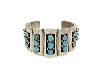 277
A Southwest sterling silver and turquoise cuff bracelet
Mid/late 20th century
Unmarked
A chunky cuff with seven domed shadowbox columns each with row-set turquoise and silver ball accents
6 3/4" inner C x 1 3/4" H, with a 1 1/4" gap
110.8 grams gross
Estimate: $400 - $600