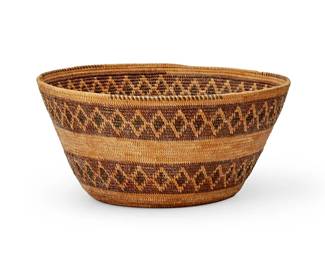 129
A Yokuts polychrome rattlesnake basket
Early 20th century; Southern California
A coiled basketry bowl with rim ticking above two bands of red and brown rattlesnake pattern motifs
5" H x 10.25" Dia.
Estimate: $1,000 - $1,500