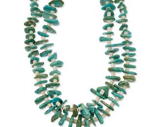 350
A Southwest Pueblo turquoise tab necklace
Mid-20th century
A double strand necklace with graduated turquoise tabs and white shell spacers, with a traditional wrapped neck cord
29" L
229.9 grams gross
Estimate: $500 - $700