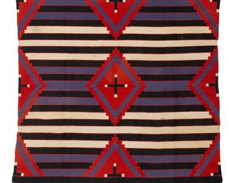 176
A Navajo Third Phase Revival wearing blanket
Early 20th century, Diné
Woven in red, purple, black, and cream wool, depicting spider woman motifs within serrated diamond motifs on a striped ground
52" H x 49.5" W
Estimate: $800 - $1,200