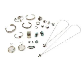 365
A large group of Southwest silver and set stone jewelry
Mid/late 20th century
Two marked for maker; one for sterling
Twenty-one works comprising five narrow cuff bracelets in various styles with various stones such as turquoise, coral and mother-of-pearl, as well as eight rings, including a cast silver ring with set brown stone, and various Zuni-style diminutive stone inlay rings, three pairs of earrings including a pair of A.C. Kokopelli motif earrings, together with two small stone inlay pendants, one a thunderbird pendant, a set turquoise brooch, an eagle motif money clip, and an unmounted turquoise cabochon, 24 pieces
Cuffs: 6" inner C to 5" inner C; rings: sizes 9 1/2 to 1 3/4; earrings: 2 1/4" H to 1/4" Dia.
177.9 grams gross
Estimate: $200 - $400