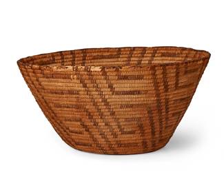 156
An Akimel O'odham/Pima basket
Early 20th century, Akimel O'odham; Southwest United States
The coiled flared basket with swirling hooked motifs
7.5" H x 16.5" Dia.
Estimate: $400 - $600