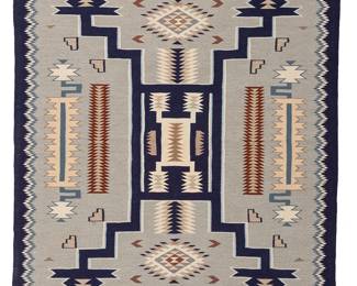 183
A Navajo regional rug
Late 20th/early 21st century, Diné
Woven in ochre, mauve, dark blue, light blue, periwinkle, grey, and natural white, depicting an elaborate storm pattern
71" H x 49.5" W
Estimate: $600 - $800