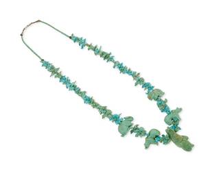 346
A Johnny Sheeka Zuni stacked turquoise fetish necklace
Johnny Sheeka [Shika] (b. 20th century, Zuni Pueblo)
Late 20th century
Unmarked
Featuring an elaborate single strand necklace of graduated stacked carved animal fetish figures, including a large central standing turquoise bear, flanked by smaller bears and hares, with various animals such as birds, foxes, turtles, and wolves and with a turquoise bead and silver cone clasp
32 1/2" L x 2 1/4" H
165.8 grams gross
Estimate: $200 - $400