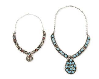 309
Two Southwest sterling silver and set stone necklaces
Late 20th century
Each stamped: Sterling; smaller partially marked: Casuse [script; possibly Fritz Casuse, b. 1968; Navajo/Diné]
Comprising a silver link necklace with cluster-set turquoise and a large central teardrop pendant, together with a set turquoise and coral silver link necklace with applied silver and scrolled designs, 2 pieces
Larger: 22 1/2" L x 2 1/2" H; smaller: 17" L x 1 3/8 "H
123.2 grams gross
Estimate: $500 - $700
