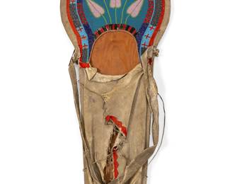 233
A Plateau beaded hide cradle board
Early 20th century
The plywood board clad in hide with felt accents, decorated in multicolored beads depicting a floral motif centering banded cross and checkered motifs
39" L x 16" W x 2.75" D
Estimate: $2,000 - $3,000