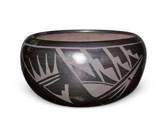 259
Carmelita Dunlap (1925-1999, San Ildefonso Pueblo)
A blackware pottery bowl, 1982
Incised signature and date to underside: Carmelita Dunlap / San Ildefonso Pueblo
The black on black bowl with geometric and eagle feather motifs to body
5.625" H x 10.75" Dia.
Estimate: $500 - $700