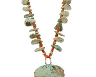 321
A Southwest Pueblo turquoise tab and coral necklace
Early/mid-20th century
With graduated tabs and coral bead spacers suspending a large turquoise slab pendant, with a wrapped neck cord
31" L x 2" H
120 grams gross
Estimate: $500 - $700