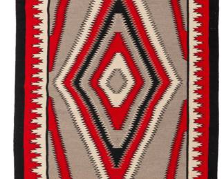191
A Navajo regional rug
Late 20th century, Diné
Woven in red, cream, black, and grey wool, depicting a central radiating serrated diamond motif in an elaborate geometric border
73" H x 41.5" W
Estimate: $500 - $700