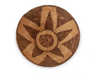160
An Apache basketry bowl
Early/mid-20th century; Southwest United States
The coiled basket with a brown central star motif
5.75" H x 11.875" Dia.
Estimate: $500 - $700
