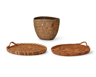 152
Three Thompson River basketry vessels
Early 20th century, Salish; Pacific Northwest
Comprising two twined polychrome basketry trays, each with opposed handles and imbricated central motif, one with an openwork piecrust rim, and a coiled berry basket with imbricated
denticulated motif
3 pieces
Larger tray: 3" H x 18.5" W x 16.25" D; Basket: 11.25" H x 13.5" W x 10.5" D
Estimate: $600 - $800
