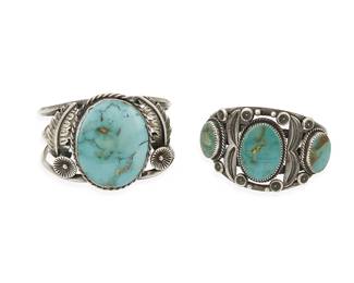 283
Two Southwest silver and turquoise cuff bracelets
Late 20th century
Smaller stamped: E / Sterling [possibly Ella Cowboy, Navajo/Diné]
Comprising a three-wire cuff with a large central set turquoise and feather overlay accents, as well as a five-wire sterling silver cuff with three oval set turquoise stones and stampwork accents, 2 pieces
Larger: 6.5" inner C x 2" H; smaller: 6" inner C x 5/8" H
139.4 grams gross
Estimate: $400 - $600