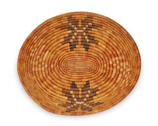 113
A California Mission polychrome basket
Early 20th century; Southern California
The coiled oval basket tray with alternating yellow and brown floral motifs
2" H x 11.75" W x 10.125" D
Estimate: $800 - $1,200