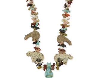 338
A Zuni Pueblo-style carved stone fetish necklace
Late 20th century
A chunky stacked carved multistone and shell fetish necklace featuring a large turquoise standing bear, as well as further bears, heartline bears, and multiple smaller wolves, bears and other animals, with a traditional wrapped neck cord
33" L x 2" H
176.7 grams gross
Estimate: $200 - $400