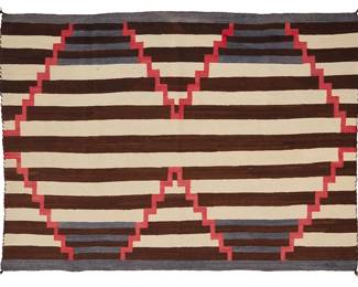 175
A Navajo Third Phase variant wearing blanket
Late 19th/ early 20th century, Diné
Woven in red, brown, cream, and blue wool, with alternating bands of stripes intersecting with conjoined stepped diamonds
74" H x 49" W
Estimate: $2,000 - $4,000
