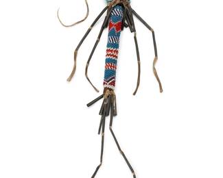 238
A Native American beaded hide awl cast
Early 20th century
The possibly Kiowa stiff hide awl sheath, adorned with beads depicting geometric banded motifs and tin cone fringe
Without fringe: 5" L
Estimate: $800 - $1,200