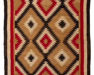 185
A Navajo regional rug
20th century, Diné
Woven in dark brown, ochre, red, and cream wool, depicting serrated conjoined diamond motifs in a striped border
84" H x 53.5" W
Estimate: $500 - $700