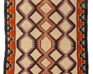 199
A Navajo regional rug
Mid-20th century, Diné
Woven in red, orange, blue, black, grey, and cream wool, depicting three columns of serrated diamonds within a stepped border
92.5" H x 49.5" W
Estimate: $500 - $700