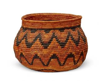 115
A California Mission polychrome basket
Early 20th century; Southern California
The coiled globular basketry vessel with flared rim, featuring a central floral motif and banded zig zag motif in red and brown
6.625" H x 9" W x 8.75" D
Estimate: $500 - $700