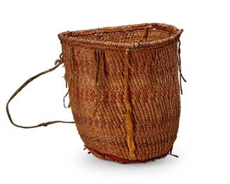 163
An Apache polychrome burden basket
Late 19th/ early 20th century; Southwest United States
The tall coiled basket with red and blue banded accents, featuring hide strapping to rim and handles, with cloth and hide reinforcement to underside
11" H x 11" Dia.
Estimate: $400 - $600