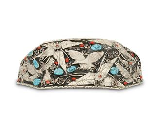 266
A Southwest silver and set stone large plaque belt buckle
Late 20th century
Stamped: JK [conjoined; within large star]
An extra-large shadow-box plaque buckle with three silver eagles and multiple clusters of feather, floral, and scrollwork overlay designs, with set turquoise and coral
4" H x 12 1/8" W
502.3 grams gross
Estimate: $700 - $900