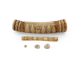 146
A Hupa carved elk antler purse
Late 19th/early 20th century
The coin purse with carved designs and sgraffito geometric motifs, the top removable, revealing two carved shell coins
6.375" L
Estimate: $400 - $600