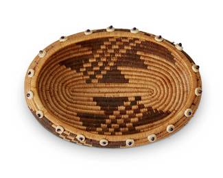 108
A Pomo gift basket
Early 20th century; Central California
The coiled low bowl with central geometric motif and clam shell trim to rim
1.5" H x 5.375" W x 3.625" D
Estimate: $400 - $600
