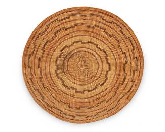 125
A Yokuts polychrome basket
Early 20th century; Central California
The coiled basketry tray with gap stitched red and brown stepped bands
2.625" H x 17.5" Dia.
Estimate: $800 - $1,200