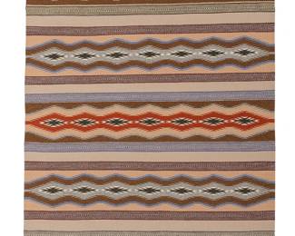 206
A Navajo regional rug
Late 20th century, Diné
Woven in multicolor wool, depicting alternating banded motifs of stacked serrated diamonds and stripes
48.5" H x 33.5" W
Estimate: $200 - $400