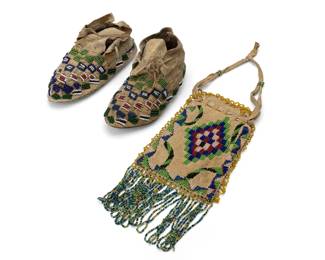 241
A pair of Plains beaded hide child's moccasins and satchel
20th century; Great Plains
Comprising a pair of possibly Sioux moccasins with beaded accents, and a hide pouch depicting central stepped diamond motifs to each side, beaded trim, and beaded fringe
3 pieces
Each moccasin: 3.375" H x 6.25" W x 2.625" D approx.; Satchel: 5.875" H x 4" W
Estimate: $500 - $700