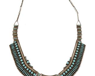 310
A Southwest Zuni-style silver and turquoise necklace
Mid-20th century
Unmarked
A silver link necklace with three row-set and needlepoint turquoise plaques suspended from a paper-clip chain
26" L x 1" H
89.0 grams gross
Estimate: $300 - $500