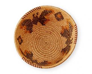 136
A Panamint polychrome pictorial basket
Early 20th century; Central California
The small coiled basket with rim ticking and yellow and brown figural butterflies alternating with floating diamond motifs
3.375" H x 5.5" Dia.
Estimate: $300 - $500