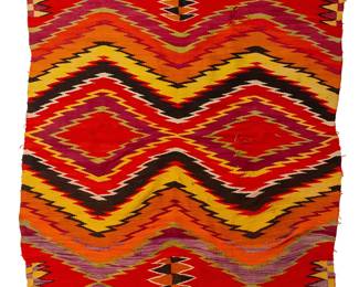 180
A Navajo transitional blanket
Late 19th/early 20th century, Diné
Woven in vibrant multicolor wools, depicting two central serrated diamonds and elaborated serrated borders
97" H x 67.5" W
Estimate: $1,000 - $2,000